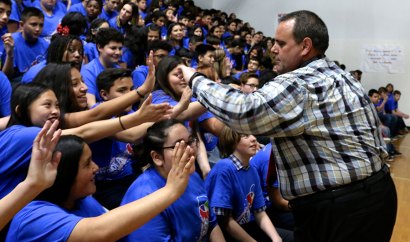 Lemoore's Liberty Middle School celebrate high fives with Principal Ben Luis during Friday's special event.